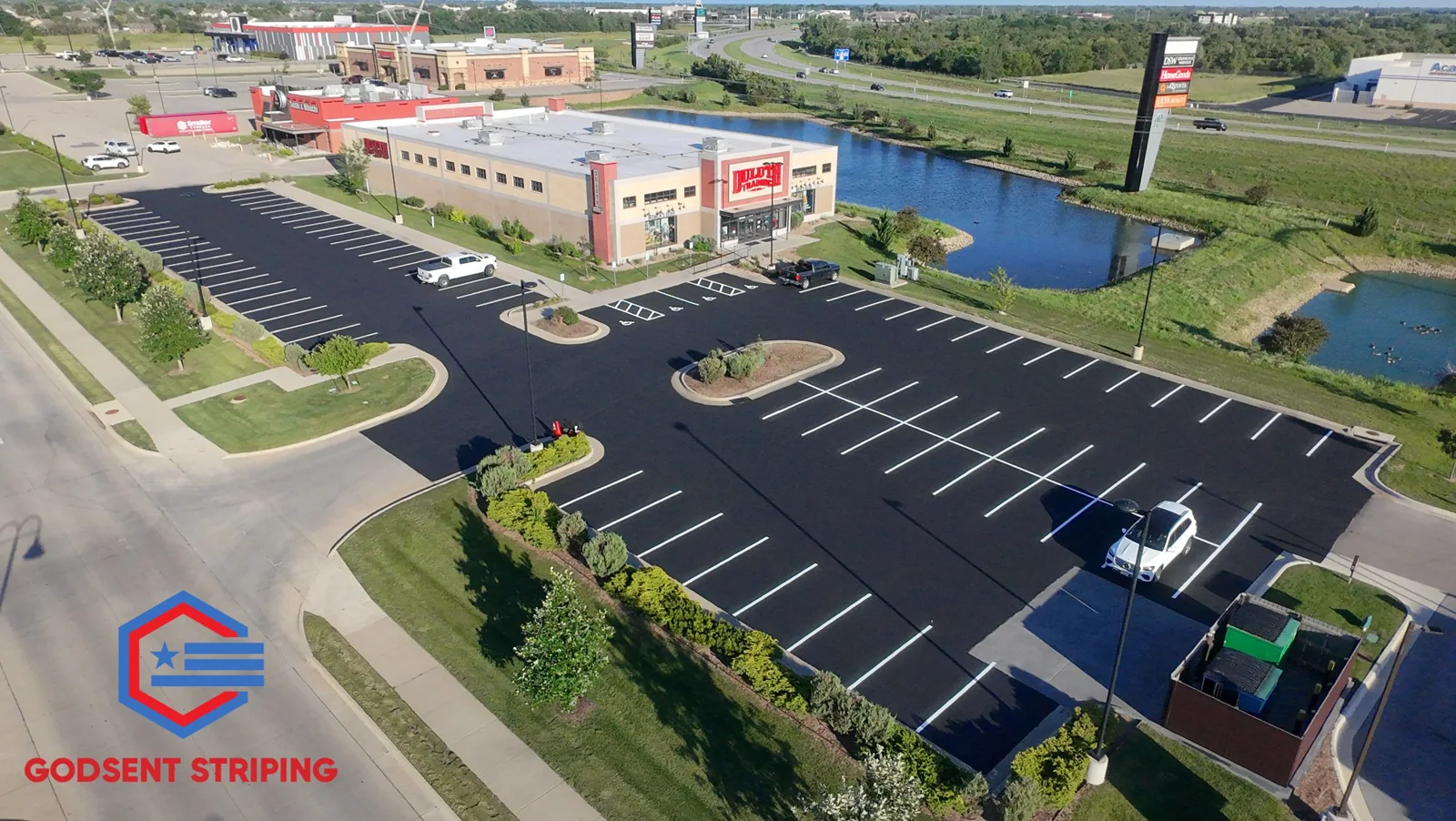 Freshly sealed and striped commercial parking lot, photographed from above
